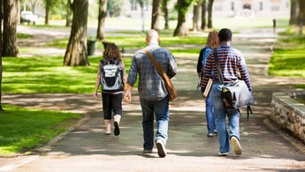 Students walk through college campus.
