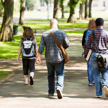 Students walk through college campus.