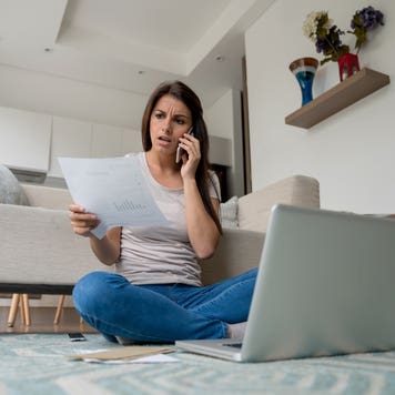 Woman at home complaining about on the phone
