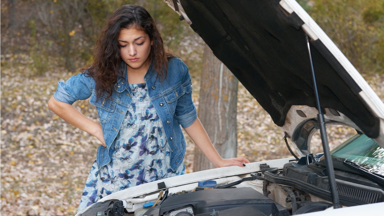 Woman under the hood of a car