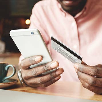 Man paying credit card with balance transfer credit card