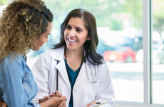 Female doctor discusses something with young woman patient