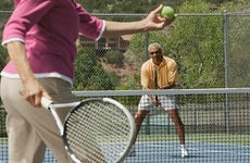 Couple playing tennis together | ERproductions Ltd/Getty Images