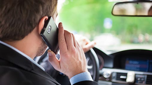 Man talking on phone while driving © Minerva Studio/Shutterstock.com