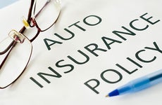 Auto insurance policy document with glasses and pen © emilie zhang/Shutterstock.com