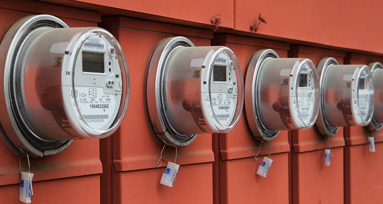 Row of electric meters on orange panels © Bobkeenan Photography/Shutterstock.com