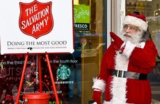 Santa Claus ringing bell, collecting donations for Salvation Army | George Rose /Getty Images