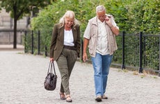 Couple walking together in city park © iStock