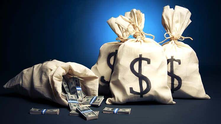 Bags of money in dark blue background © Fer Gregory/Shutterstock.com