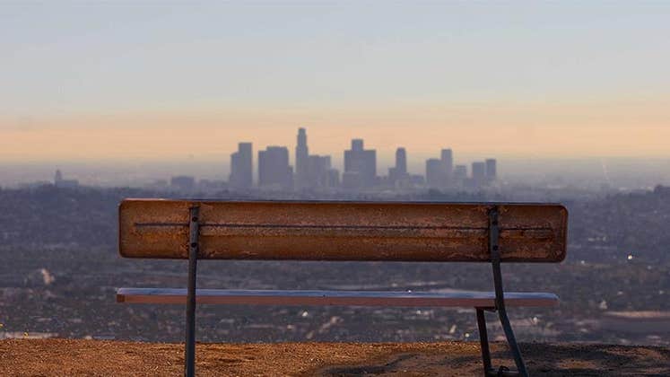 Empty bench overlooking city view | Travis Price/Getty Images