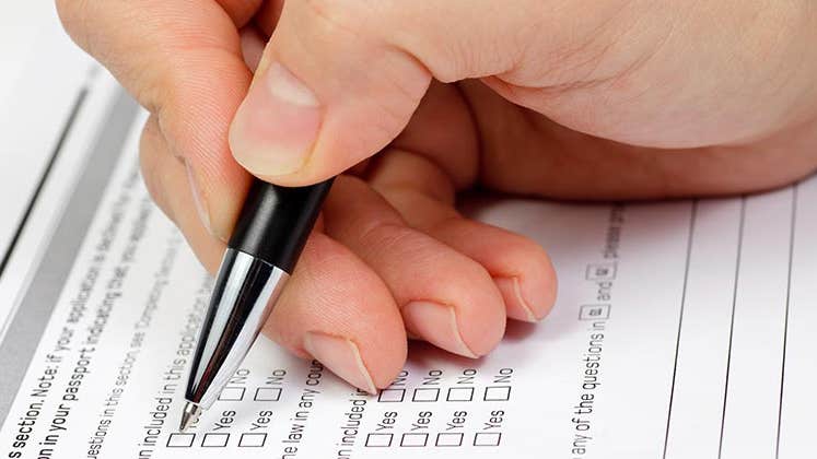 Hand with pen over blank checkboxes in a form © Dmitry Naumov/Shutterstock.com 