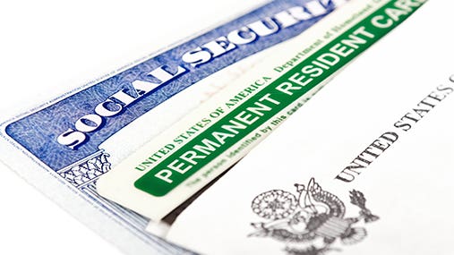 Green card with Social Security card © Leena Robinson/Shutterstock.com