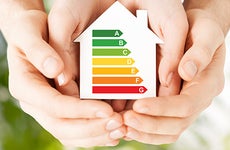 Hands holding energy rating house cutout © syda productions/Shutterstock.com