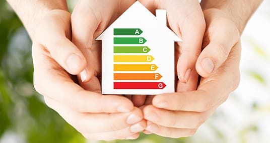 Hands holding energy rating house cutout © syda productions/Shutterstock.com