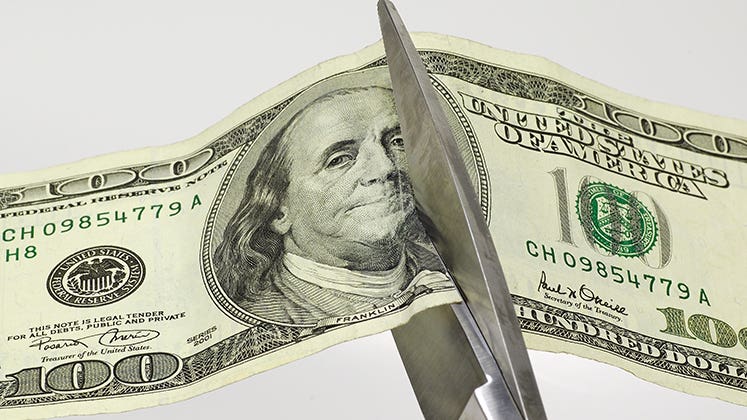 $100 bill being cut with a scissor © Scott Rothstein/Shutterstock.com