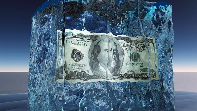 $100 bill frozen in ice © iStock