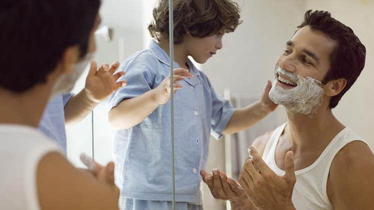 Toddler helping his father shave © Air Images/Shutterstock.com
