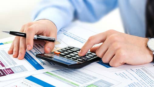 Male hands doing financial calculations © Zadorozhnyi Viktor/Shutterstock.com