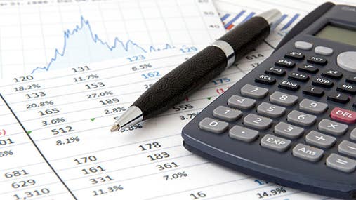 Financial objects stock chart calculator and pen © atm2003/Shutterstock.com