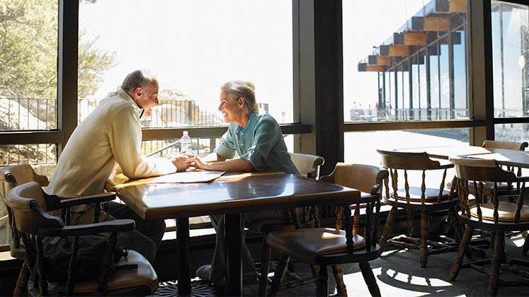 Senior couple seated at a restaurant table | Siri Stafford/Getty Images