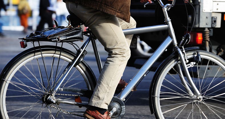 Man riding bicycle to work © iStock