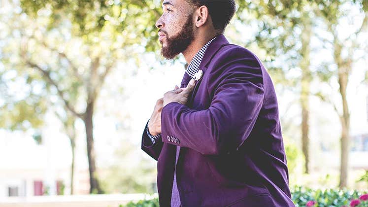 Young man wearing purple suit | William Stitt/Unsplash