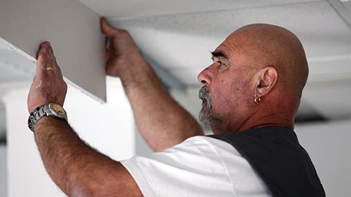 Tradesman installing drywall © auremar/Shutterstock.com
