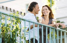 Couple standing on terrace © MJTH/Shutterstock.com