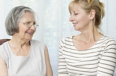 Mother and daughter sitting together in living room © baki/Shutterstock.com