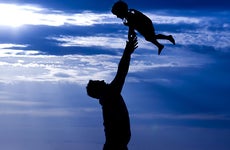 Father tossing son silhouette on a beach © Mehmet Dilsiz/Shutterstock.com
