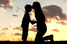 Mother kissing son's forehead © Christin Gasner/Shutterstock.com