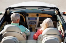 Senior couple in convertible car © iStock