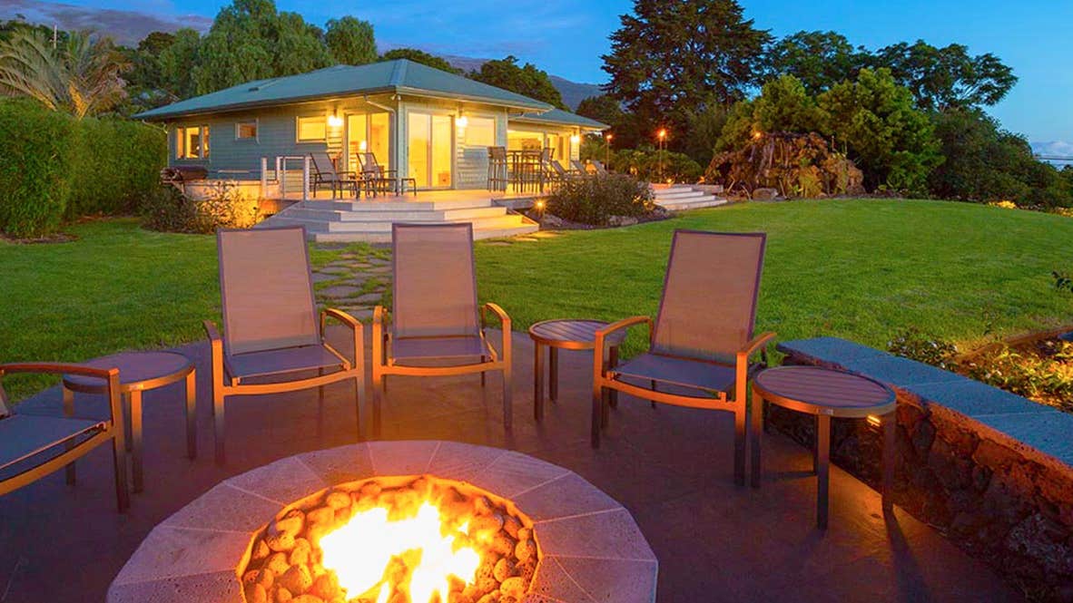 Patio with fireplace behind a house