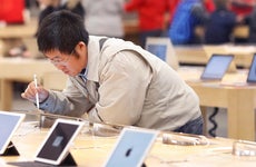 Man looking at iPads in an Apple store