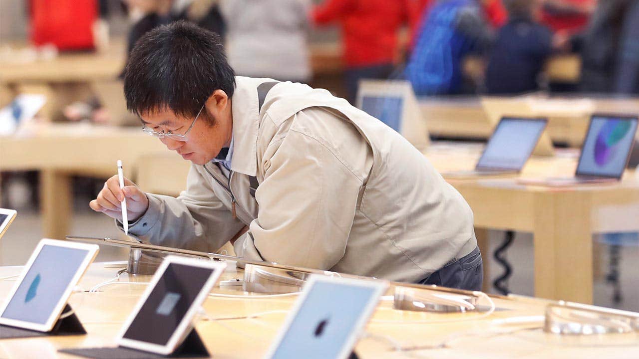 Man looking at iPads in an Apple store