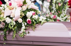 Casket covered in flowers