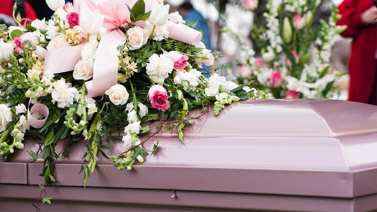 Casket covered in flowers
