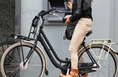 Woman at atm on bike