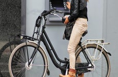 Woman at atm on bike