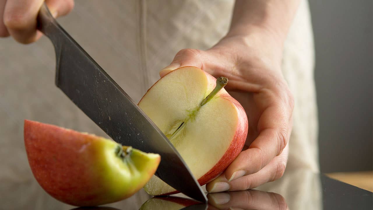 woman cutting apple