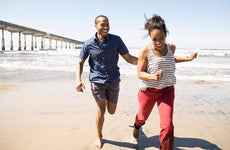 Young couple running on the beach