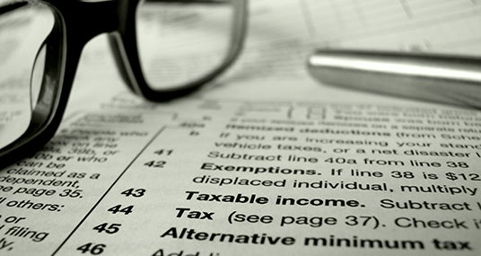 Close up of tax forms with eyeglasses and pen  © Mr Doomits /Shutterstock.com