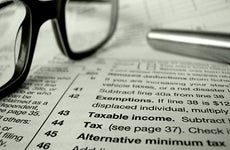 Close up of tax forms with eyeglasses and pen  © Mr Doomits /Shutterstock.com
