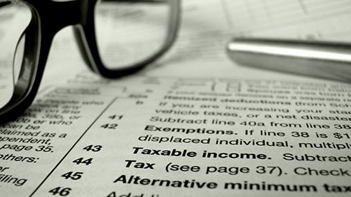 Close up of tax forms with eyeglasses and pen  © Mr Doomits /Shutterstock.com