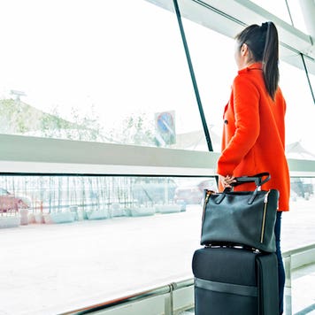 Woman looking out of airport window © iStock