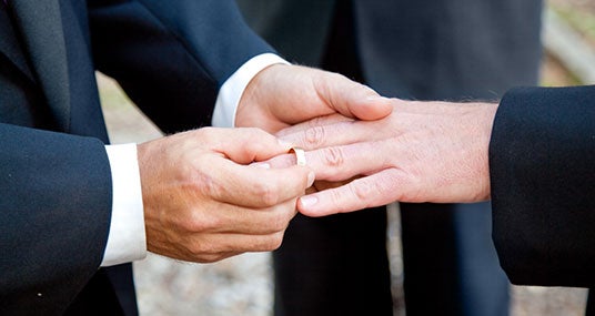 Men exchanging rings at wedding © Lisa F. Young/Shutterstock.com