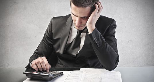Man worried calculating tax return © olly - Fotolia.com
