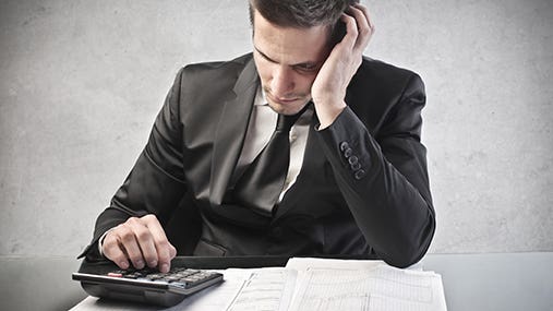Man worried calculating tax return © olly - Fotolia.com