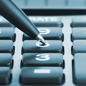 Pen pushing calculator numbers © doomu/Shutterstock.com