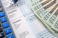 Form 1040 focused on exemptions section and calculator © Kimberly Reinick - Fotolia.com